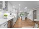 Bright, open kitchen with a center island, wine cooler, and seamless flow to the dining area at 4931 Pine Ridge Rd, Charlotte, NC 28226