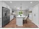 Bright kitchen featuring a large island, stainless steel appliances, and modern white cabinetry at 4931 Pine Ridge Rd, Charlotte, NC 28226