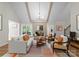 Open-concept living room featuring a fireplace, hardwood floors, comfortable seating and bright light at 4931 Pine Ridge Rd, Charlotte, NC 28226