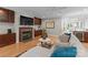 Comfortable living room showcasing a fireplace, hardwood floors, and stylish built-in cabinets and shelving at 4931 Pine Ridge Rd, Charlotte, NC 28226