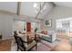 Inviting living room featuring vaulted ceilings, a cozy seating area, and view to kitchen at 4931 Pine Ridge Rd, Charlotte, NC 28226
