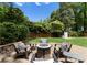 Beautiful backyard patio features a fire pit, seating, and lush greenery, creating a serene outdoor retreat at 4931 Pine Ridge Rd, Charlotte, NC 28226