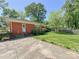 Brick house with a well-maintained lawn and lush landscaping in the backyard at 5119 Beckford Dr, Charlotte, NC 28226