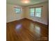 Spacious bedroom filled with natural light from two windows and hardwood floors at 5119 Beckford Dr, Charlotte, NC 28226