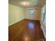 Bright bedroom featuring hardwood floors, large windows, and neutral paint at 5119 Beckford Dr, Charlotte, NC 28226