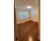 Bedroom with neutral walls, hardwood floors, and two windows with blinds at 5119 Beckford Dr, Charlotte, NC 28226