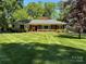 Charming brick home with a well-maintained lawn and mature trees at 5119 Beckford Dr, Charlotte, NC 28226