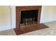Close up of a red brick fireplace with metallic gold accents and a white mantel at 5119 Beckford Dr, Charlotte, NC 28226