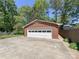 Spacious brick garage with a multi-panel white door and concrete driveway at 5119 Beckford Dr, Charlotte, NC 28226