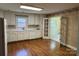 Bright kitchen featuring white cabinets, appliances, and hardwood floors at 5119 Beckford Dr, Charlotte, NC 28226