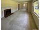 Large living room with a brick fireplace and bright natural light at 5119 Beckford Dr, Charlotte, NC 28226