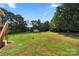 Spacious backyard with a storage shed and mature trees offers plenty of room for outdoor activities and relaxation at 5303 Rogers Rd, Monroe, NC 28110