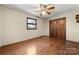 Bedroom featuring a wooden floor and closet with a ceiling fan at 5303 Rogers Rd, Monroe, NC 28110
