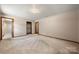 This bedroom features neutral carpeting and paint with access to an ensuite bathroom at 5303 Rogers Rd, Monroe, NC 28110