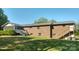 Back of brick home, with a screened porch and multiple decks and staircases, with a generously sized backyard at 5303 Rogers Rd, Monroe, NC 28110