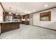 Bright, spacious kitchen featuring granite countertops, stainless steel appliances and dark wood cabinetry at 5303 Rogers Rd, Monroe, NC 28110