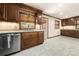 This kitchen features wood cabinets, granite countertops, and a stainless steel dishwasher at 5303 Rogers Rd, Monroe, NC 28110