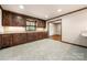Well-appointed kitchen featuring granite countertops, wood cabinetry and access to the adjacent room at 5303 Rogers Rd, Monroe, NC 28110