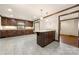 A spacious kitchen offers a large kitchen island, lots of cabinets, and bright recessed lighting at 5303 Rogers Rd, Monroe, NC 28110