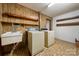 Functional laundry room with vintage washer and dryer hook ups, and ample shelf storage at 5303 Rogers Rd, Monroe, NC 28110