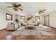 Spacious, neutral living room featuring hardwood floors, decorative ceiling fans and modern furnishings at 5303 Rogers Rd, Monroe, NC 28110