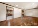 Wood floors enhance this light-filled living area with doorways leading to the kitchen at 5303 Rogers Rd, Monroe, NC 28110