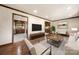Bright and airy living room with hardwood floors, neutral tones, and seamless flow to the kitchen at 5303 Rogers Rd, Monroe, NC 28110