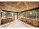 The screened-in porch offers serene outdoor living and wooded views at 5303 Rogers Rd, Monroe, NC 28110
