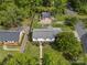 Spacious property showcases a neatly maintained lawn, auxiliary garage, and a classic two-story house from a birds-eye perspective at 6035 Idlebrook Dr, Charlotte, NC 28212