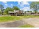 A spacious backyard featuring lush grass, a covered patio, and a well-maintained lawn at 6035 Idlebrook Dr, Charlotte, NC 28212