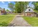 Detached brick garage with a large driveway and outdoor deck, set in a green yard at 6035 Idlebrook Dr, Charlotte, NC 28212