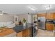 Bright kitchen features stainless appliances, a kitchen island with range, and lots of cabinets at 6035 Idlebrook Dr, Charlotte, NC 28212
