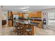 Spacious kitchen with wooden cabinetry, stone countertops, a functional island, and eat-in seating, offering plenty of workspace at 6035 Idlebrook Dr, Charlotte, NC 28212