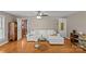 Cozy living room with wood floors, ceiling fan, and an adjacent doorway with decorative glass at 6035 Idlebrook Dr, Charlotte, NC 28212
