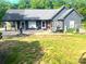 This home boasts a spacious backyard perfect for entertaining, complete with a large patio area at 605 Brookside Dr, Monroe, NC 28110