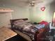 The primary bedroom features a ceiling fan and ample natural light at 605 Brookside Dr, Monroe, NC 28110