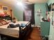 This cozy bedroom offers a comfortable retreat with a ceiling fan and generous natural light at 605 Brookside Dr, Monroe, NC 28110