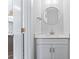A bright half bathroom with a round mirror, white vanity, and modern faucet at 714 Falling Oak Aly # 18, Huntersville, NC 28078