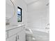 Bright, modern bathroom with white vanity, round mirror, and a shower-tub combo at 714 Falling Oak Aly # 18, Huntersville, NC 28078
