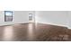 Spacious bedroom boasting hardwood floors and large windows for natural light, offering a versatile living space at 714 Falling Oak Aly # 18, Huntersville, NC 28078