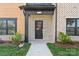 Inviting front entrance with brick accents, tidy landscaping, and a covered porch featuring the house number at 714 Falling Oak Aly # 18, Huntersville, NC 28078