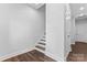 Bright hallway featuring hardwood floors, a staircase, and neutral paint, creating a welcoming transition space at 714 Falling Oak Aly # 18, Huntersville, NC 28078
