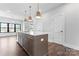 Kitchen island with quartz countertops, sink, and pendant lighting, ideal for meal prep and casual dining at 714 Falling Oak Aly # 18, Huntersville, NC 28078