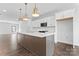 Well-lit kitchen featuring white cabinets, stainless steel appliances, and a spacious island for meal preparation at 714 Falling Oak Aly # 18, Huntersville, NC 28078
