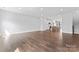 Open-concept living space featuring hardwood floors and seamlessly connecting to a bright, modern kitchen at 714 Falling Oak Aly # 18, Huntersville, NC 28078