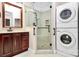 Bathroom featuring a glass-enclosed shower, modern vanity, and stackable washer/dryer at 729 Lochaven Rd, Waxhaw, NC 28173