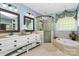 Bright primary bathroom featuring double vanity, soaking tub, and glass enclosed shower at 729 Lochaven Rd, Waxhaw, NC 28173