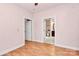 Light bedroom with hardwood floors, multiple doors, and easy bathroom access at 729 Lochaven Rd, Waxhaw, NC 28173