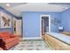 Comfortable bedroom with bright blue walls, featuring a whimsical rug and a connecting bathroom at 729 Lochaven Rd, Waxhaw, NC 28173