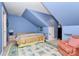 Inviting bedroom under sloped ceilings, featuring an area rug and a cozy chair at 729 Lochaven Rd, Waxhaw, NC 28173